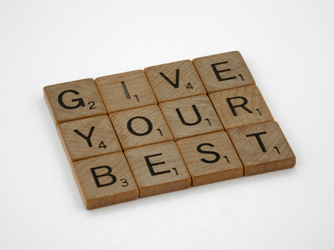 the words give your best written on wooden blocks