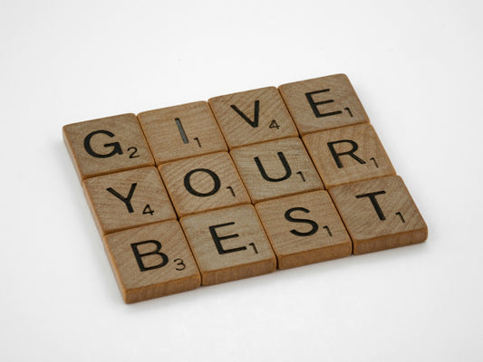 the words give your best written on wooden blocks