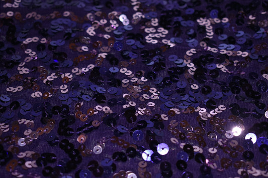 a close up of a purple sequinized surface