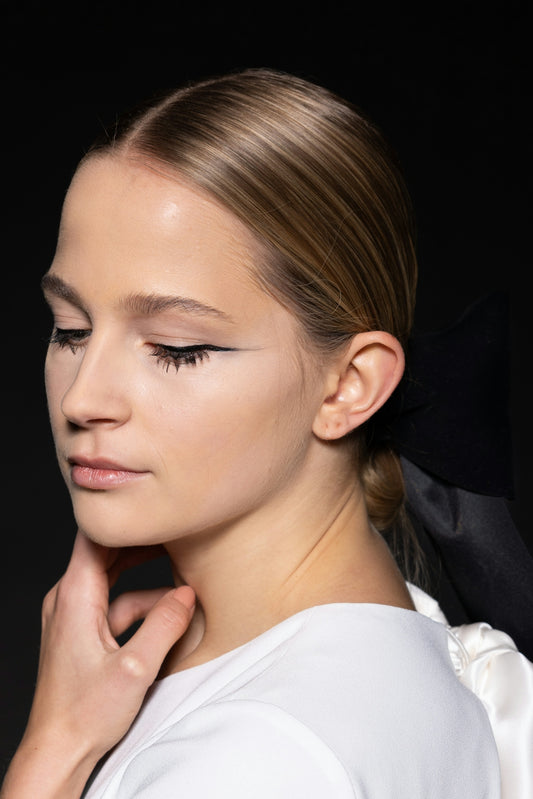 a woman with a black bow in her hair