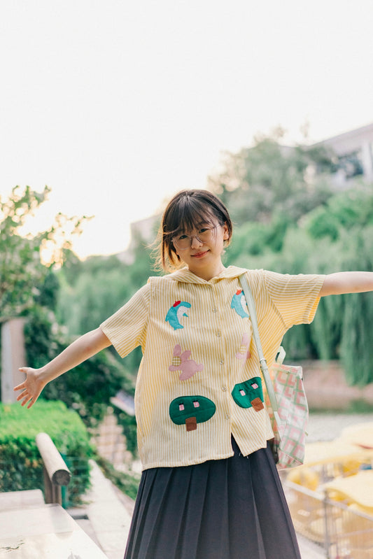 A woman in a yellow sweater and black skirt