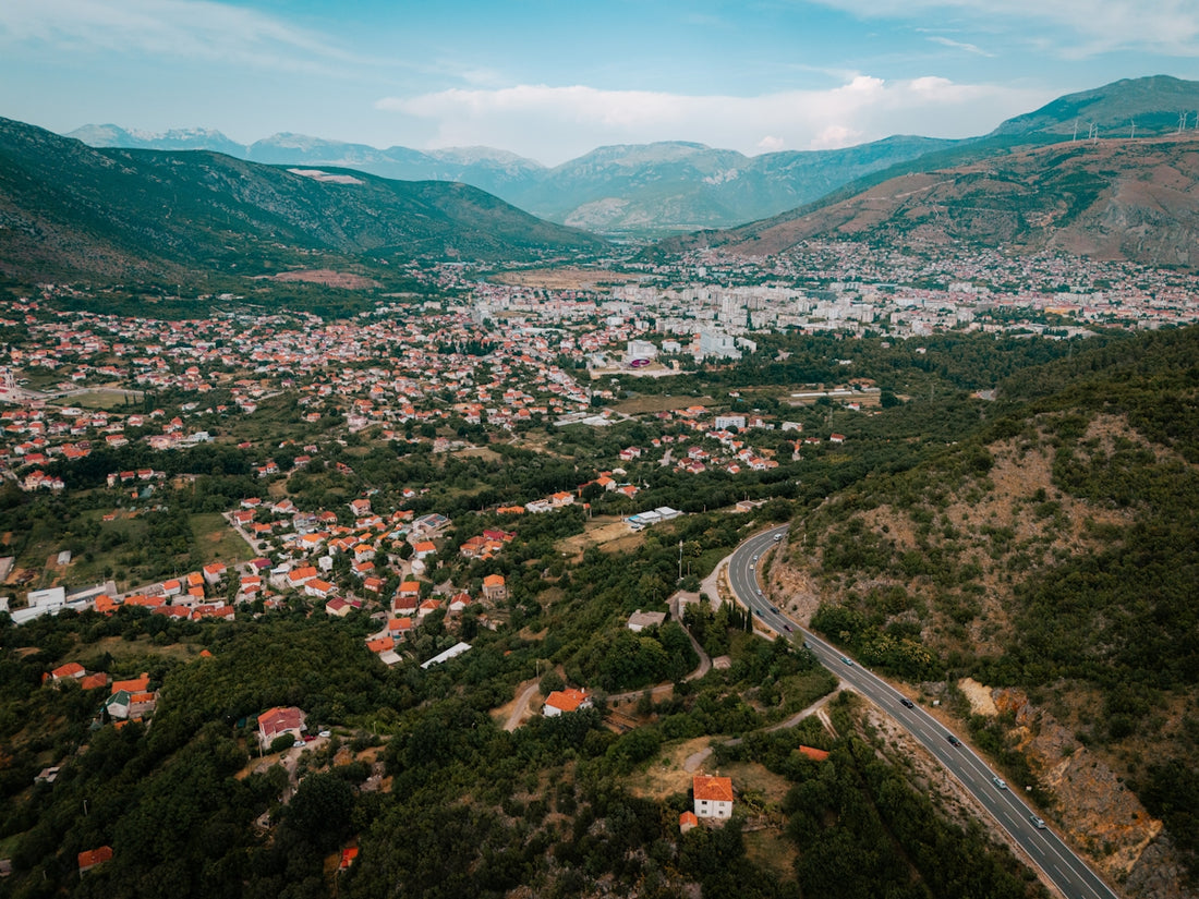 An aerial view of a city with mountains in the background