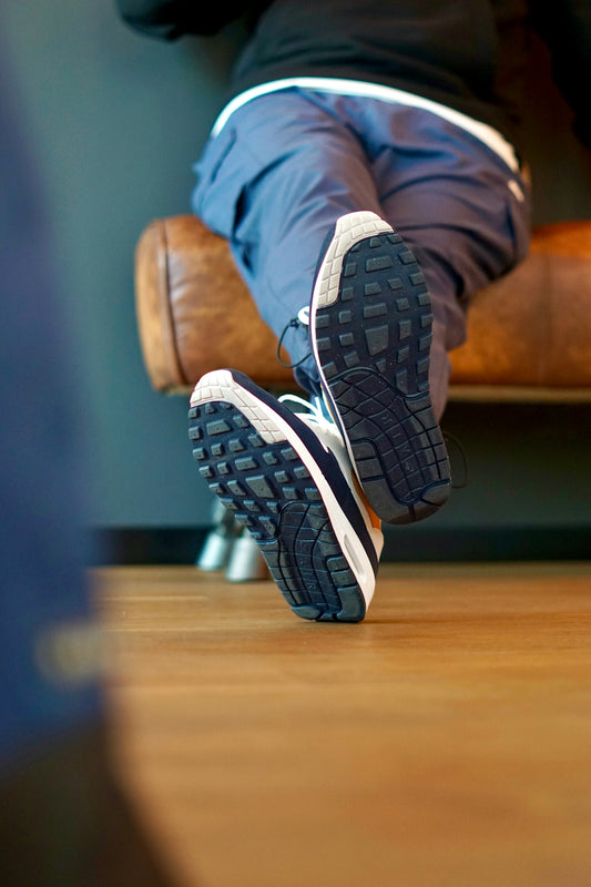 A person sitting on a chair with their feet up