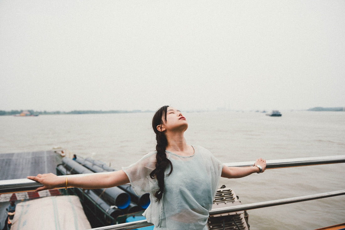 Woman with arms outstretched, enjoying the fresh air.