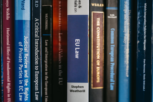 Books about law are neatly arranged on a shelf.