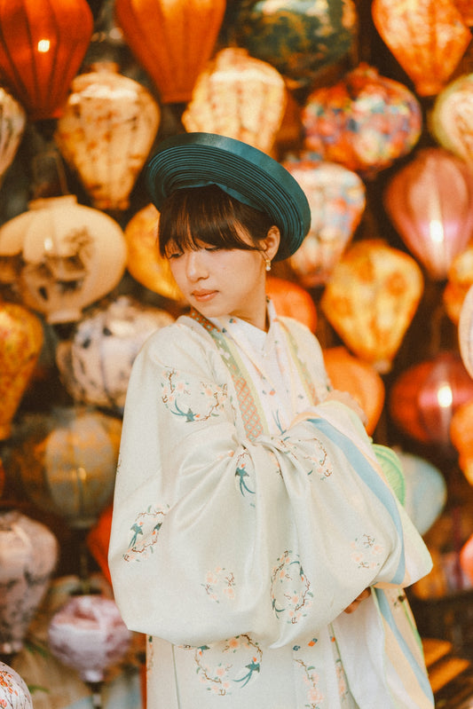Woman in traditional vietnamese dress among colorful lanterns