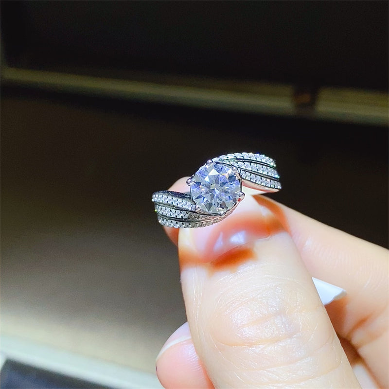 1 carat Moissanite 925 sterling silver ring with sparkling band, displayed on a finger.
