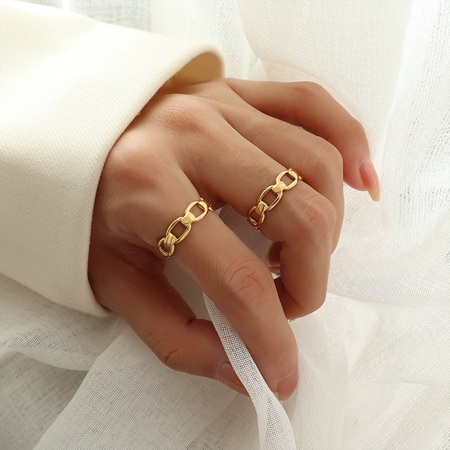 Titanium steel gold-plated adjustable ring on a hand, showcasing elegant chain design and stylish look.