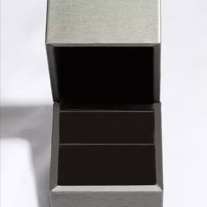 Open gray jewelry box interior, perfect for storing 1 Carat Moissanite 925 Sterling Silver Ring.