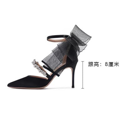 Black high heel sandal with rhinestones, pointed toe, and bow design. Heel height: 8 cm. 2024 elegant summer bridal shoe.